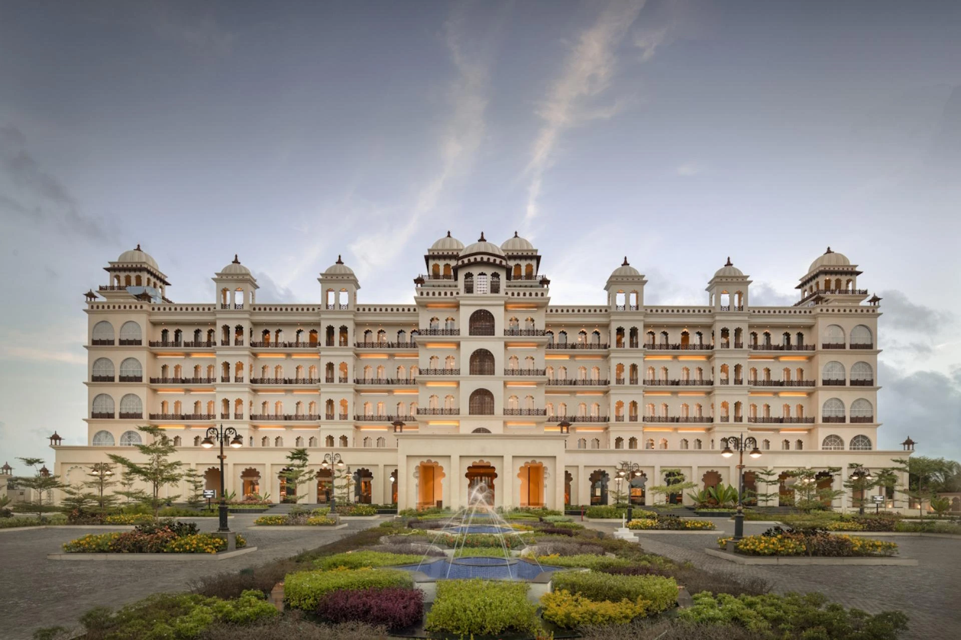 How do hotel management firms enhance guest satisfaction levels?