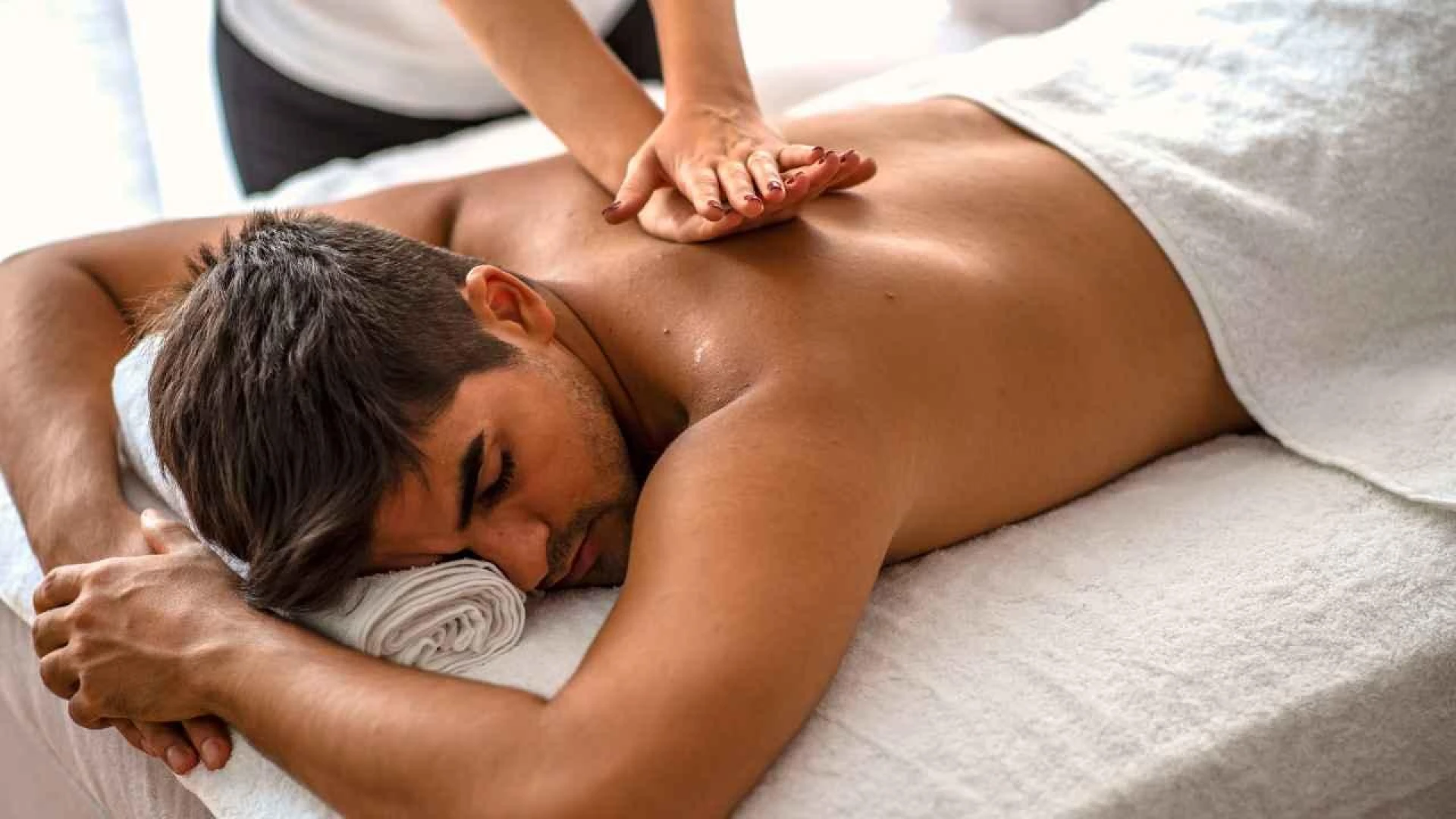 A person lying down on a massage table

AI-generated content may be incorrect.